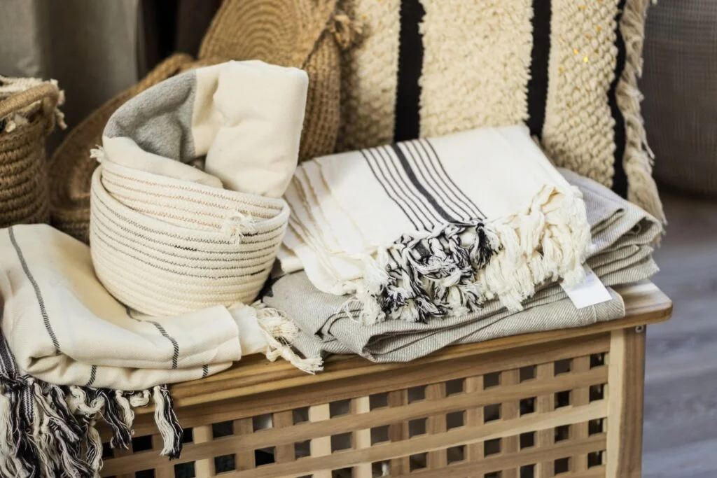 white and black floral textile on brown woven armchair. Classic Coastal Style fabrics and textures. 