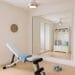 Coastal Home Gym with wood floor mat, white hall tree, white workout bench