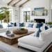 Coastal Living Room with white sofas and blue throw pillows, a fireplace and a wood coffee table