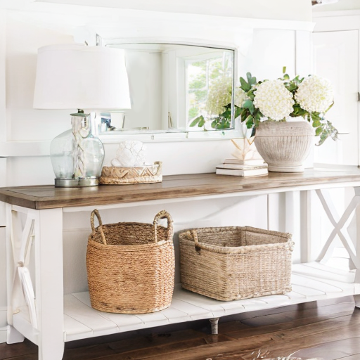 Coastal Entryway with glass table lamp, ceramic vase, white mirror, baskets and rattan tray