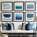 Chic coastal wall gallery with a upholstered cream bench and blue throw pillows